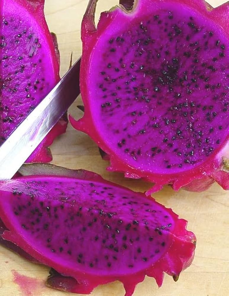 Ripe purple dragon fruit with magenta flesh